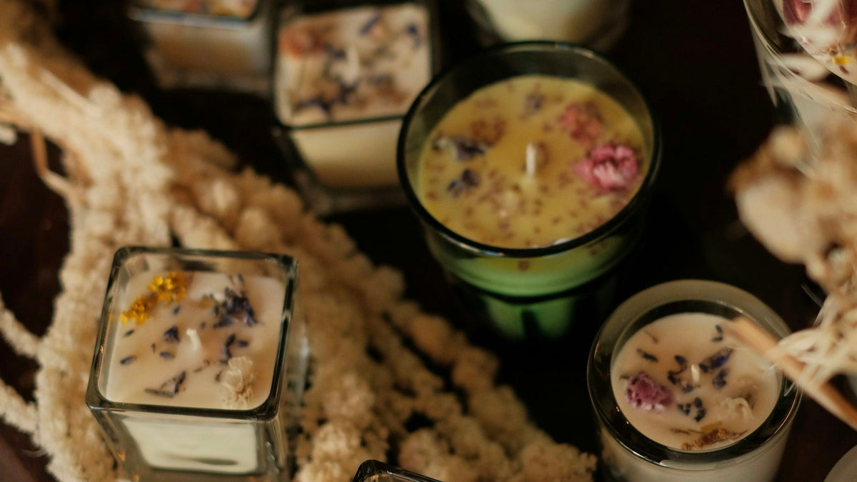 Soy wax candles with dried flowers in glass jars from above