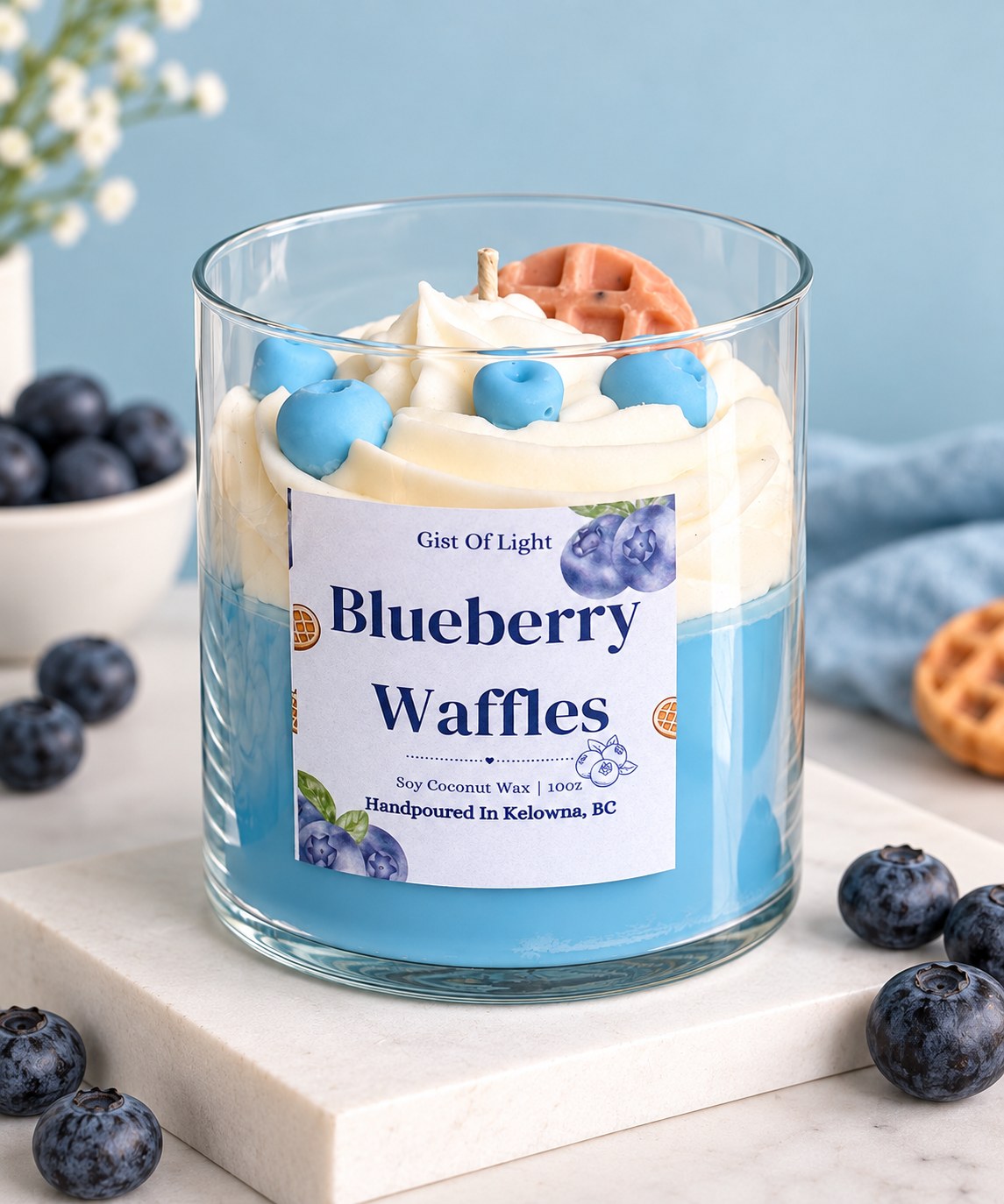 Blueberry Waffles dessert candle on a marble slab with fresh blueberries and a waffle