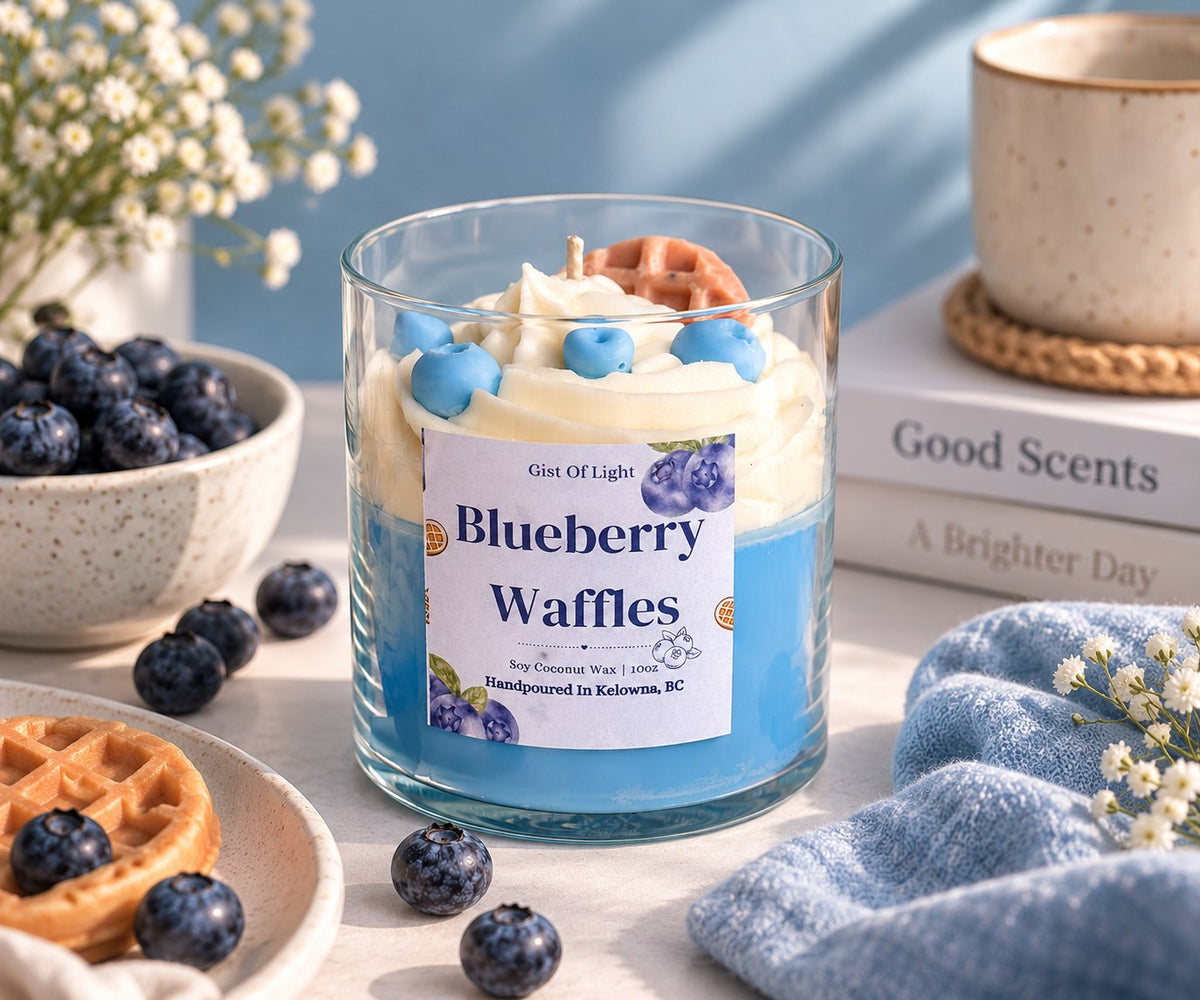 Blueberry Waffles candle on a breakfast table with coffee, books and a bowl of blueberries
