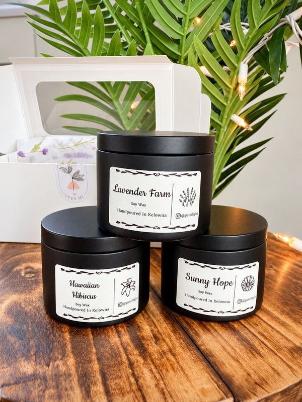 Floral Trio gift box with three black tin candles: Lavender Farm, Hawaiian Hibiscus and Sunny Hope