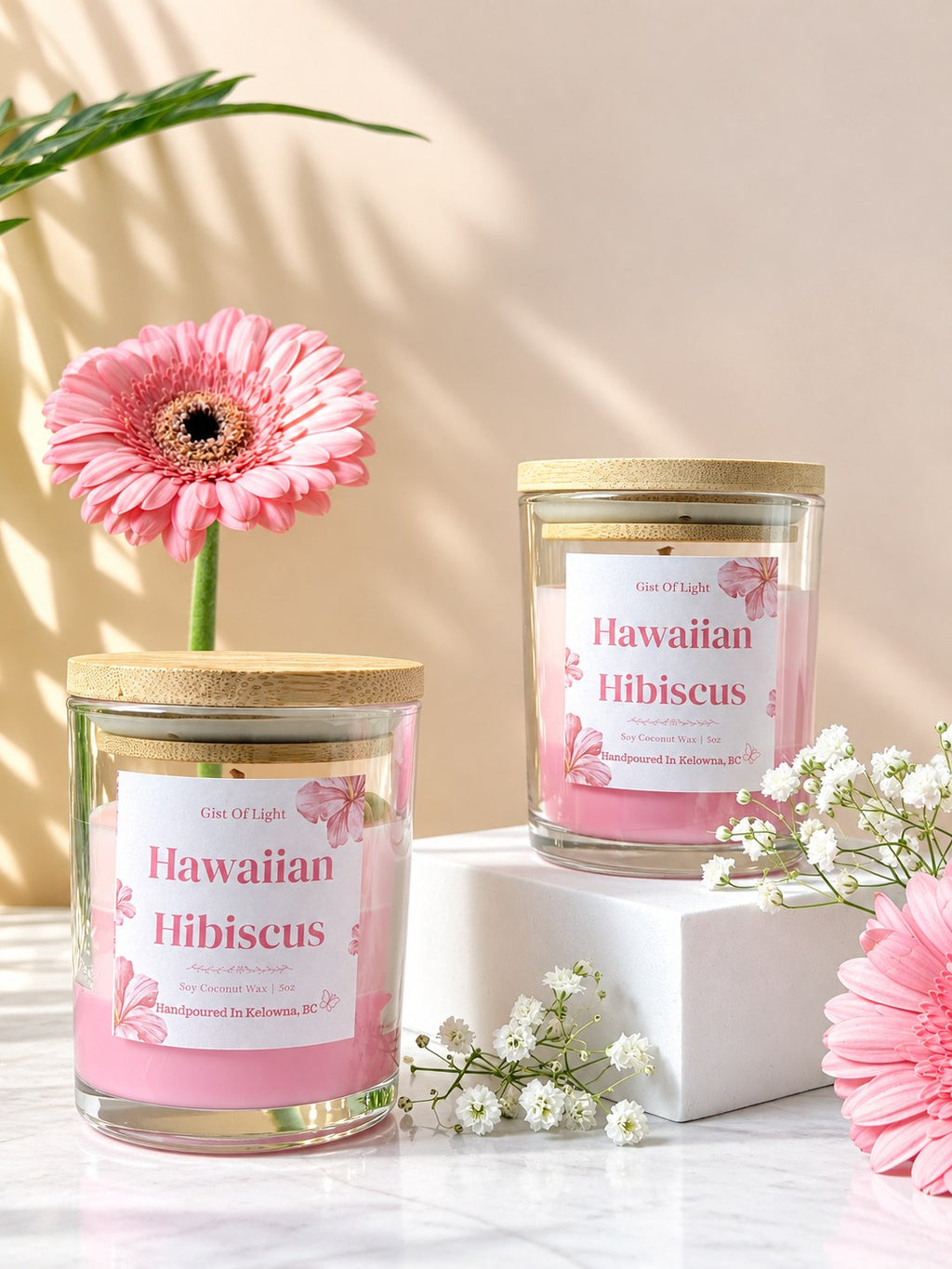 Two lidded Hawaiian Hibiscus tropical floral candles with pink gerbera daisies