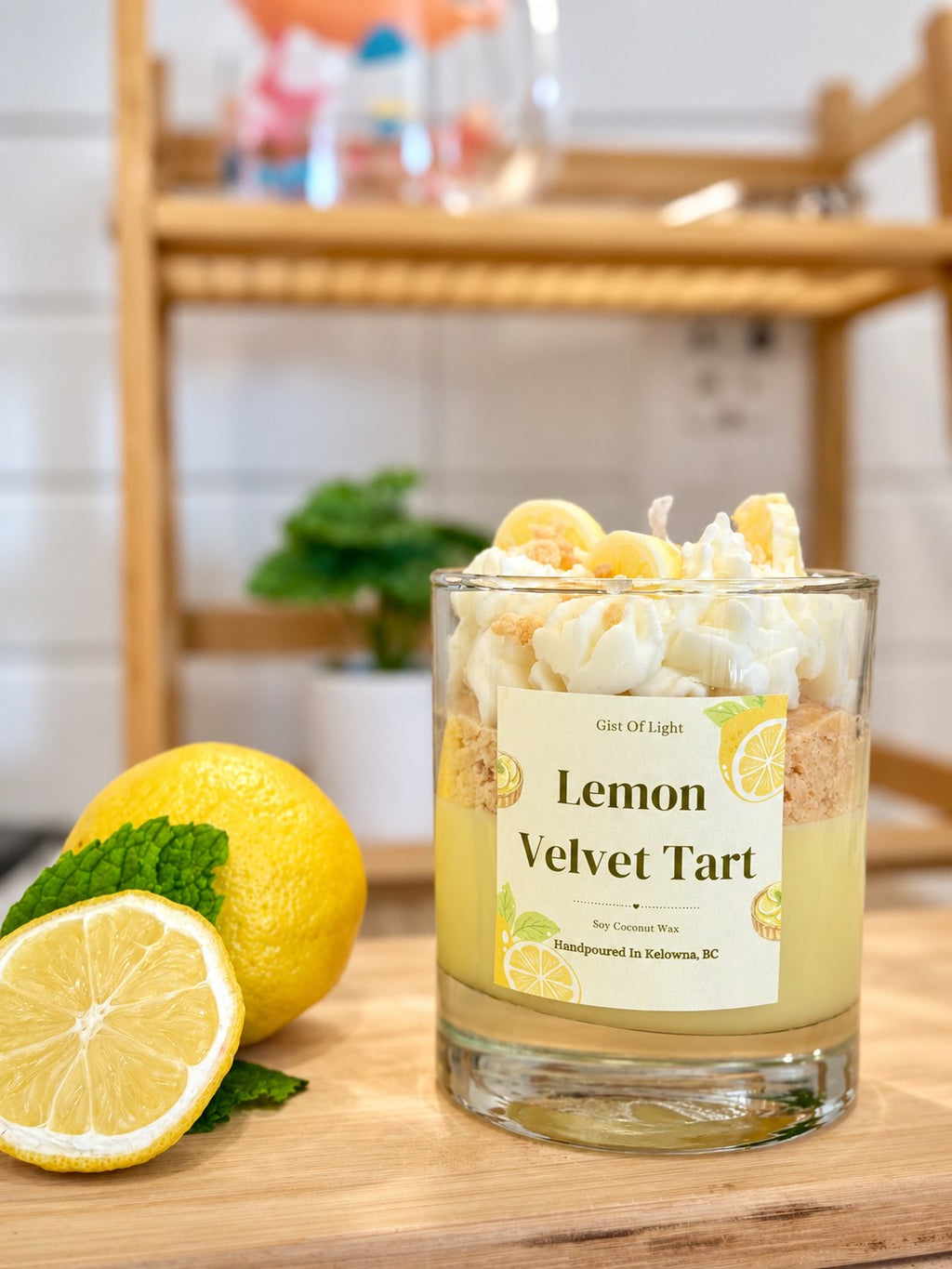 Lemon Velvet Tart candle on a kitchen counter with fresh lemons and mint