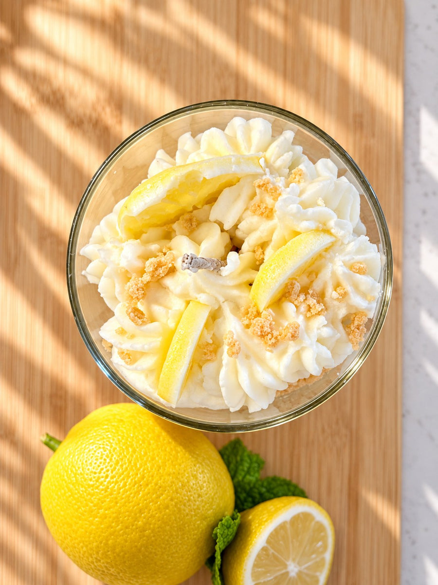 Lemon Velvet Tart candle from above showing the hand-piped whipped wax, moulded wax lemon wedges and golden crumble
