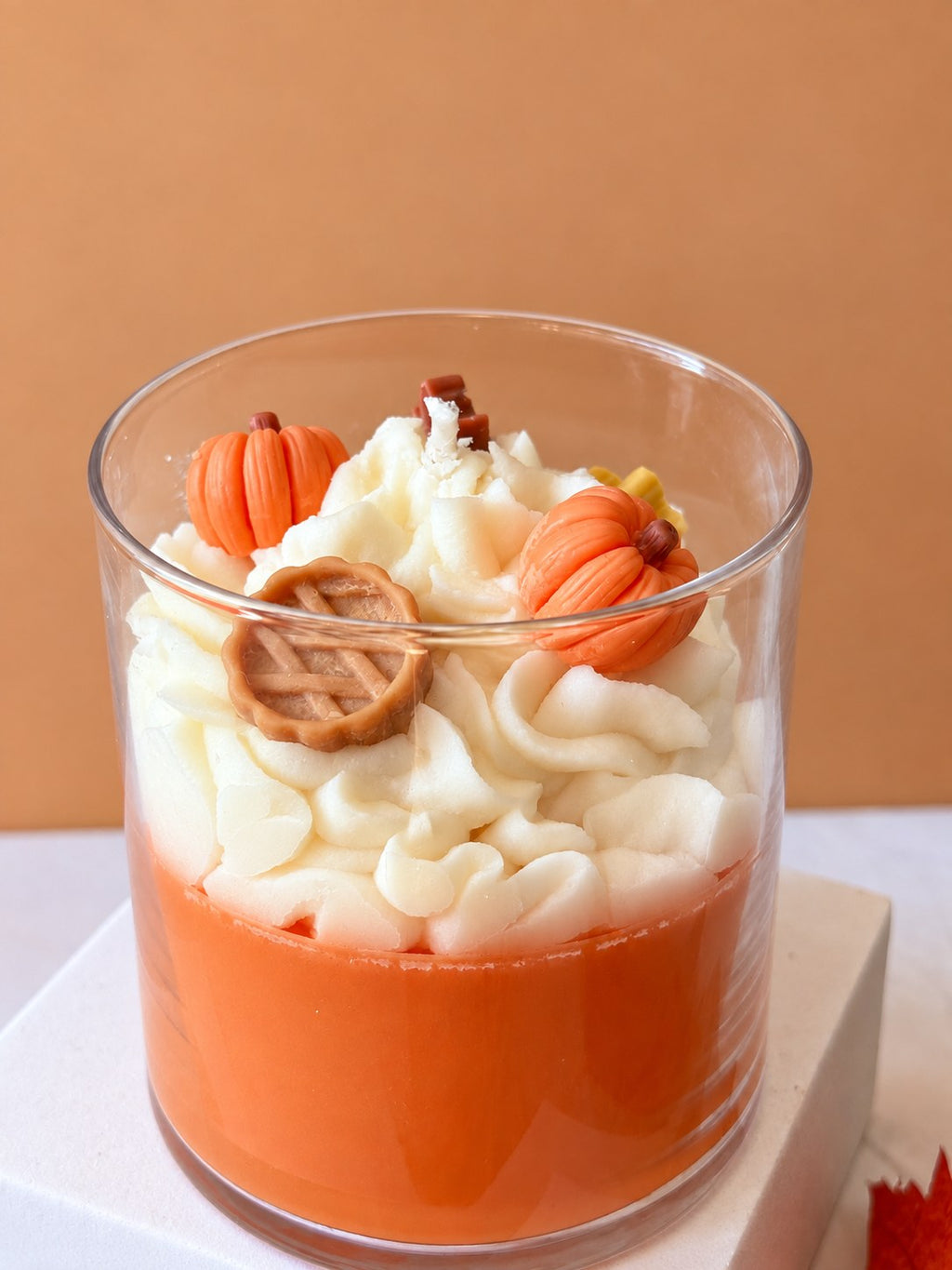 Close up of the Pumpkin Pie Delight candle with piped whipped wax, moulded wax pumpkins and a lattice pie
