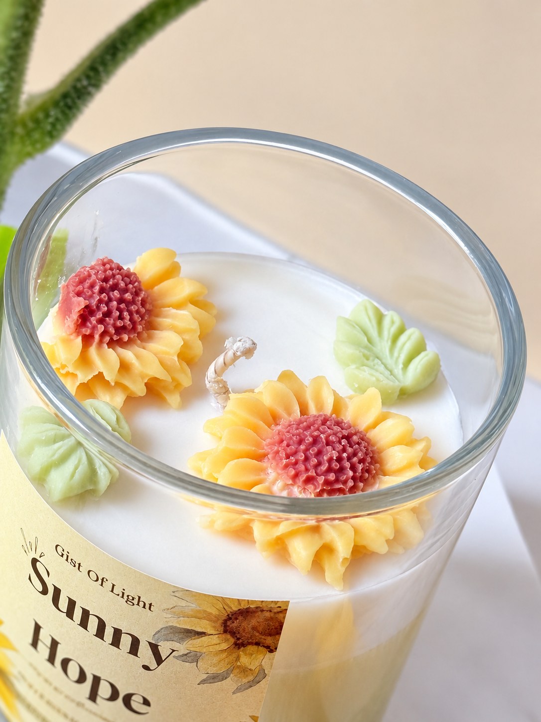Close up of the wax sunflowers and cotton wick on the Sunny Hope candle
