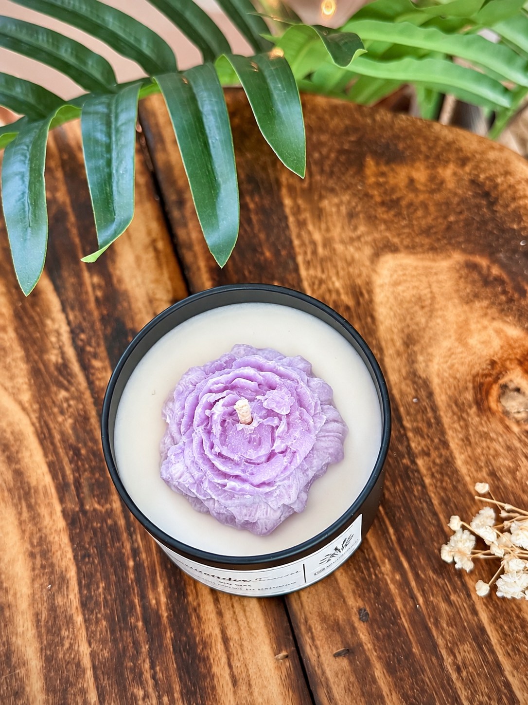 Lavender Paradise tin candle with a purple moulded wax flower on white soy wax