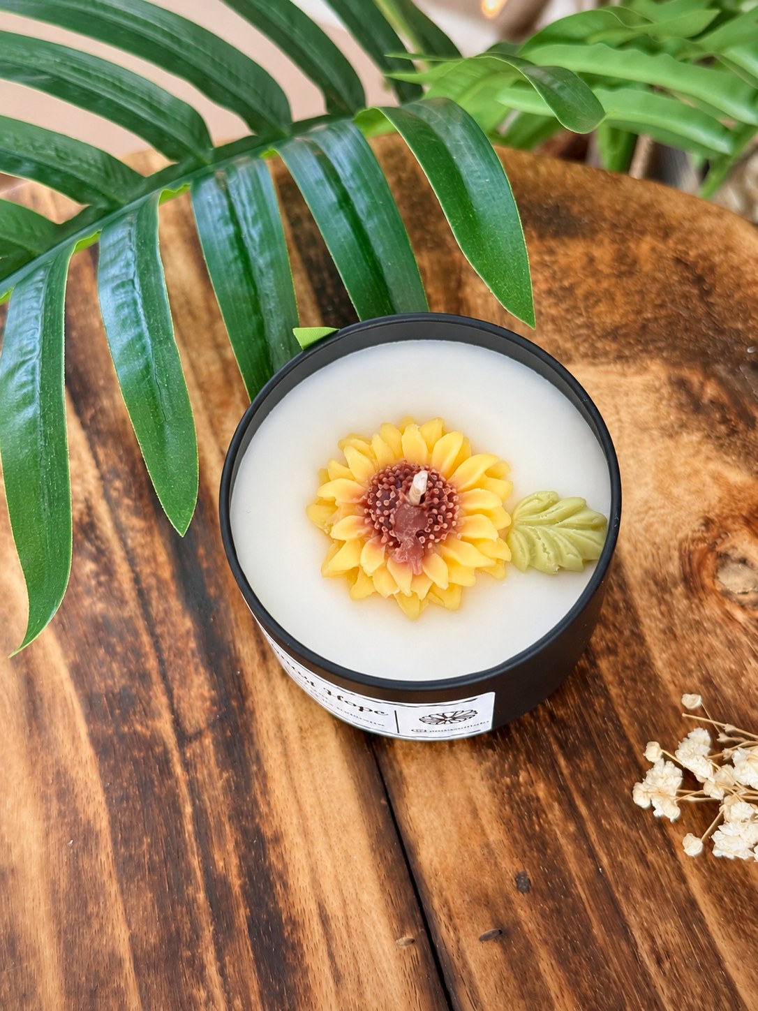 Sunny Hope tin candle with a yellow moulded wax sunflower and green wax leaf